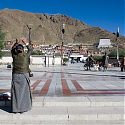 Pilgrim prostrating outside Tashilunpo Monastery, Shigatse, Tibet.