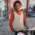 Tibetan man selling goats heads, Shegar, Tibet.